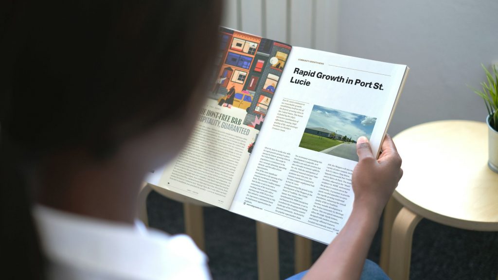 Person reading Port St. Lucie Talks Magazine featuring an article titled 'Rapid Growth in Port St. Lucie'