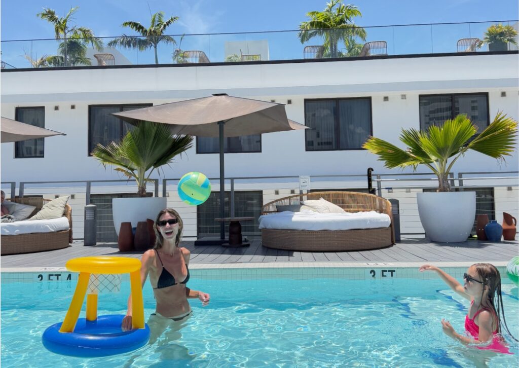 Rooftop pool with lounge chairs overlooking Miami Beach at Uma House hotel.