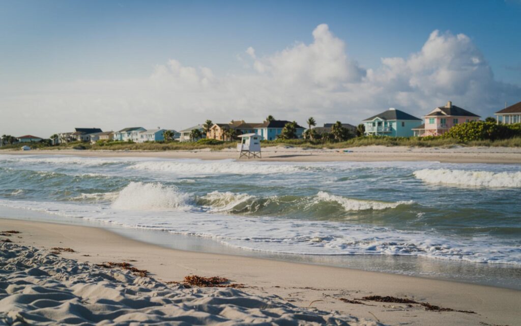 South Florida beach with rough surf and clear skies signaling drier air and coastal hazards.