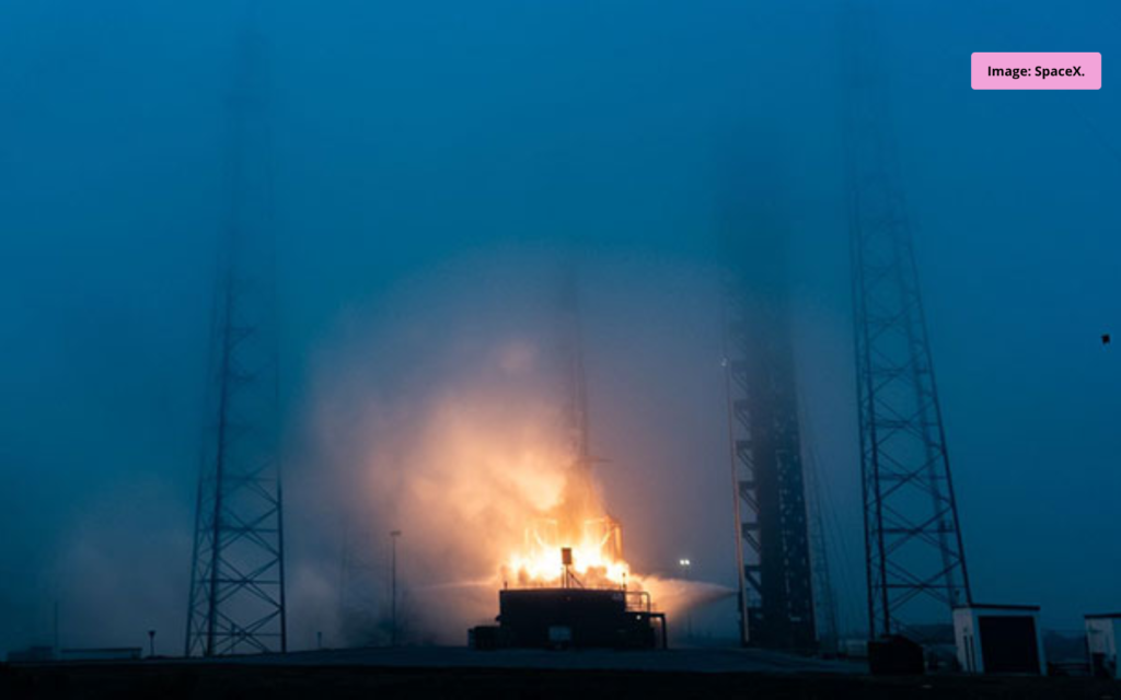 SpaceX rocket soaring into the night sky during liftoff
